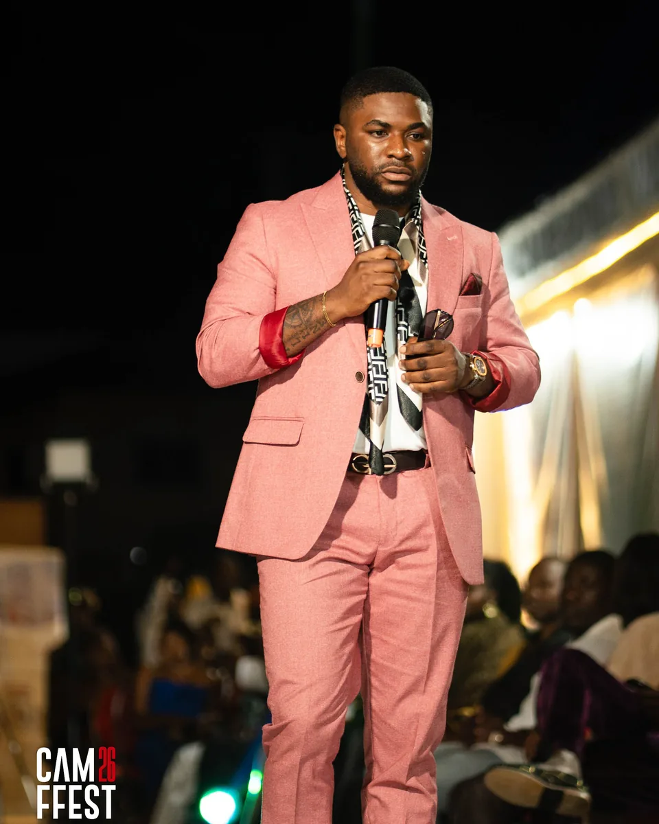 Host in a pink suit with a microphone
