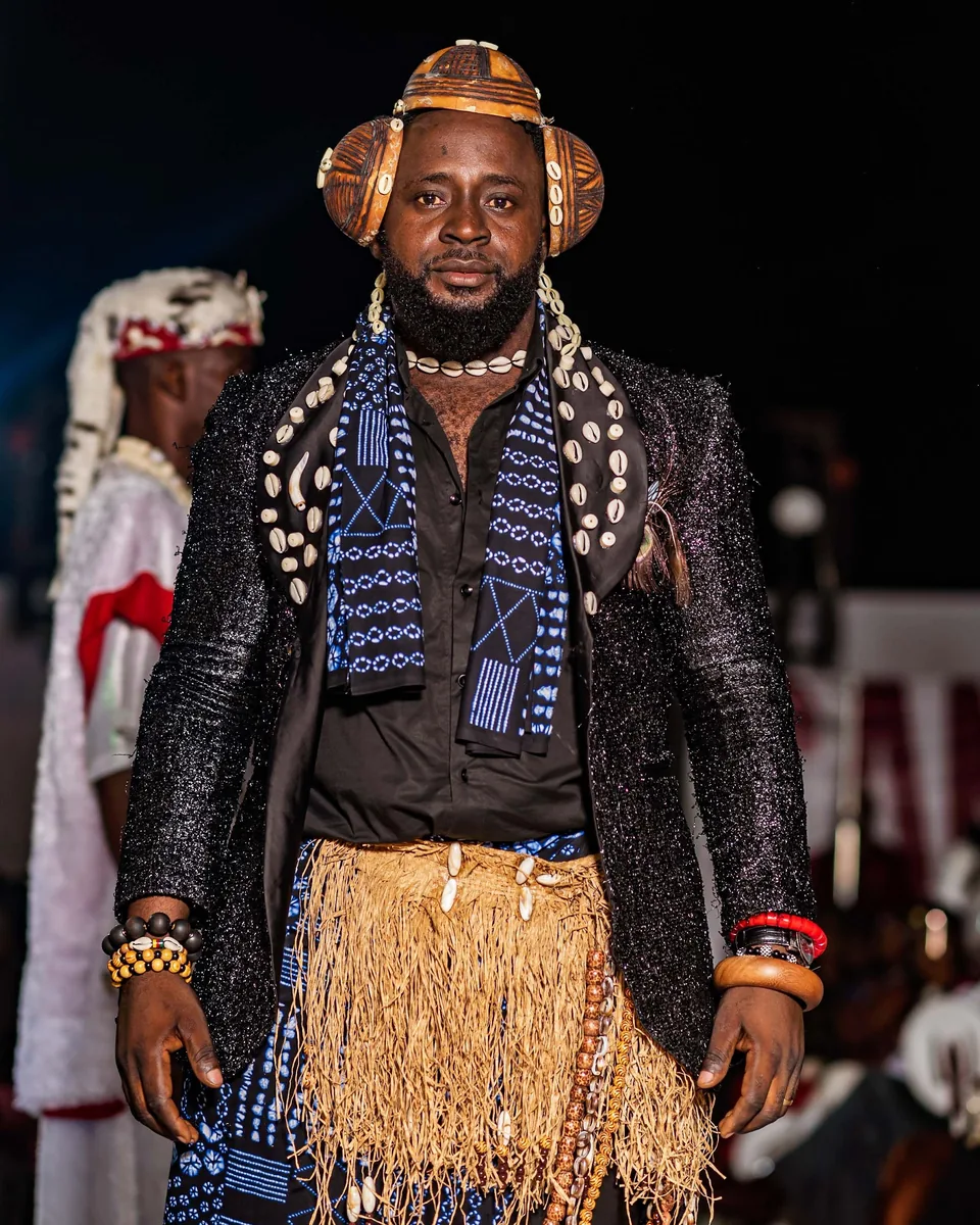 Model in a raffia skirt and beaded traditional dress