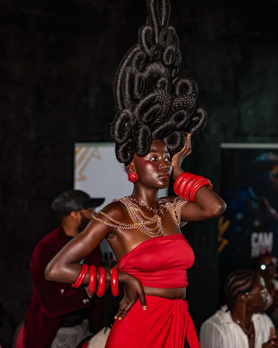 Model in a towering braided headpiece and red two-piece