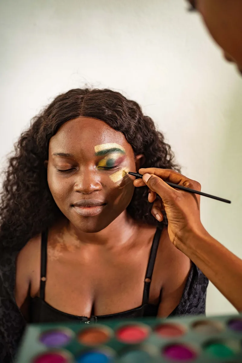 Makeup artist painting a model’s eyes