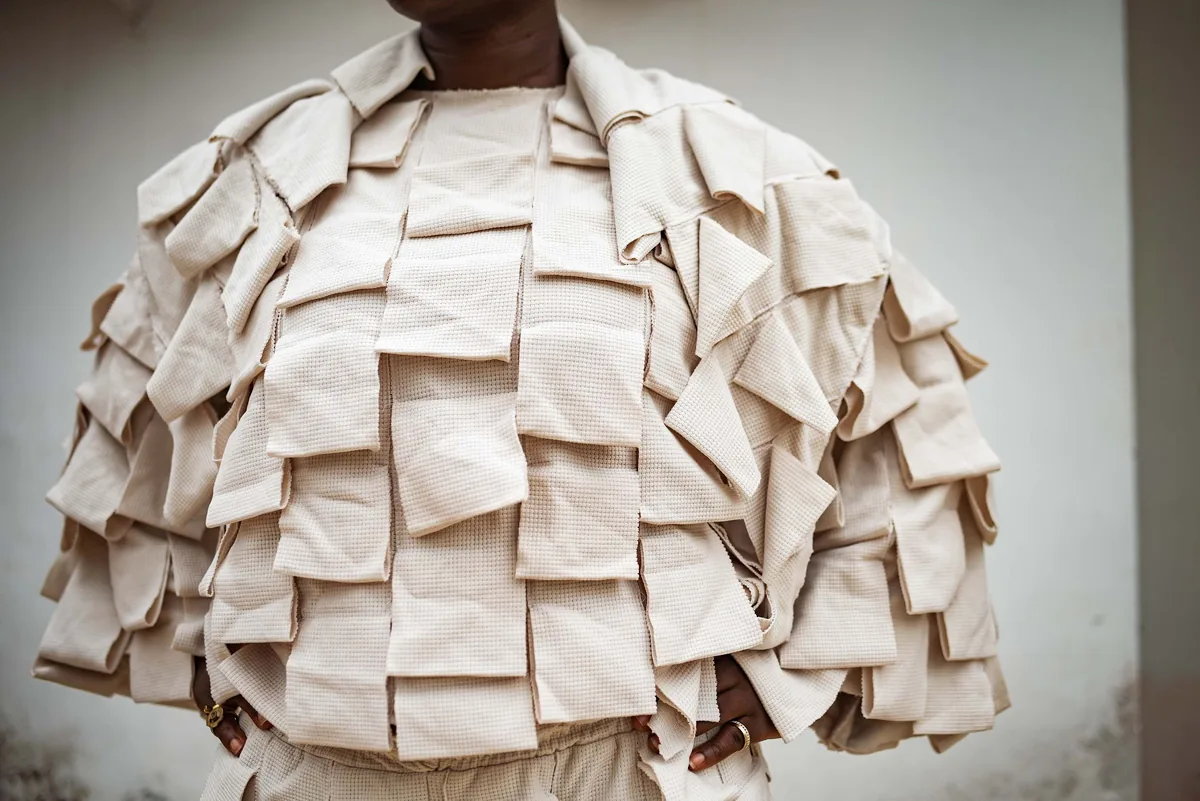 Sculptural jacket made of folded cream panels