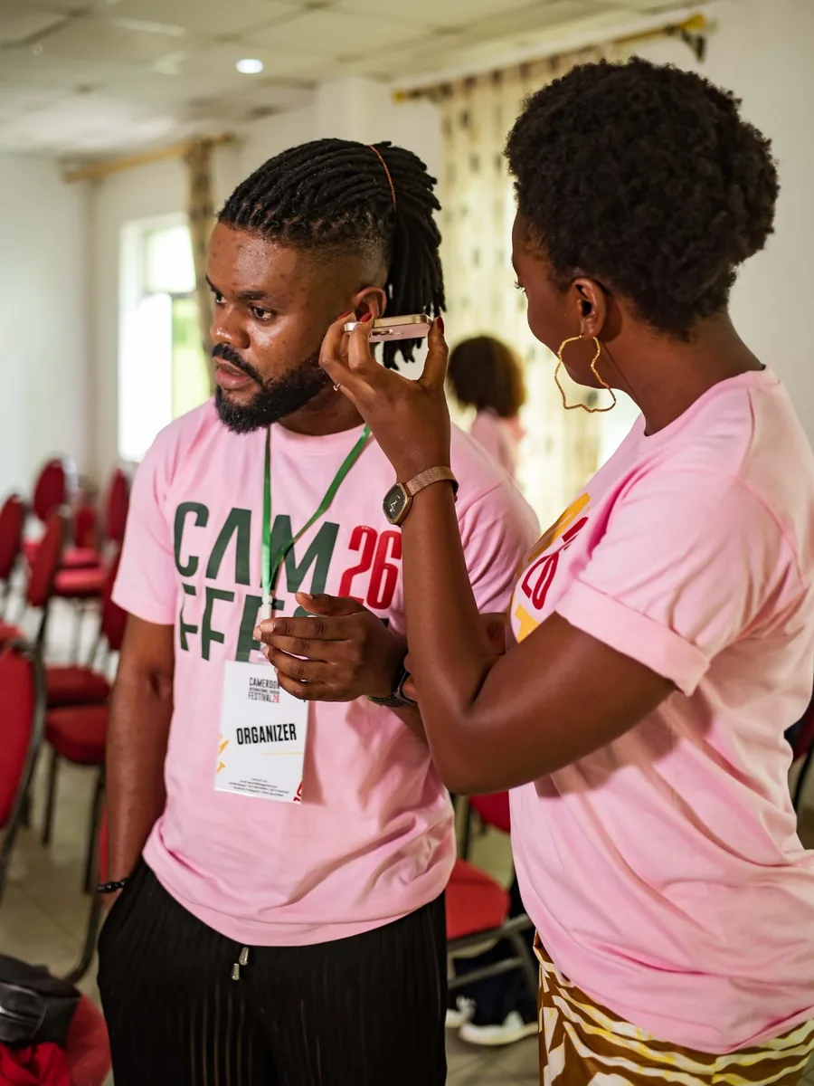 Two participants in CAMFFEST t-shirts at a workshop